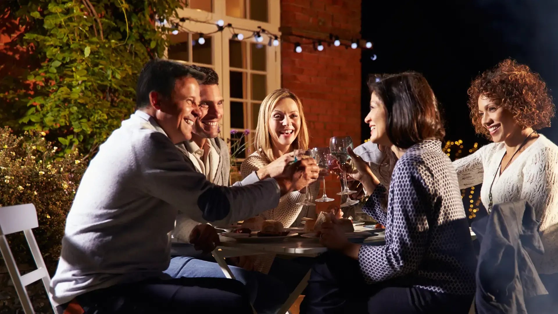 People enjoying dinner and wine